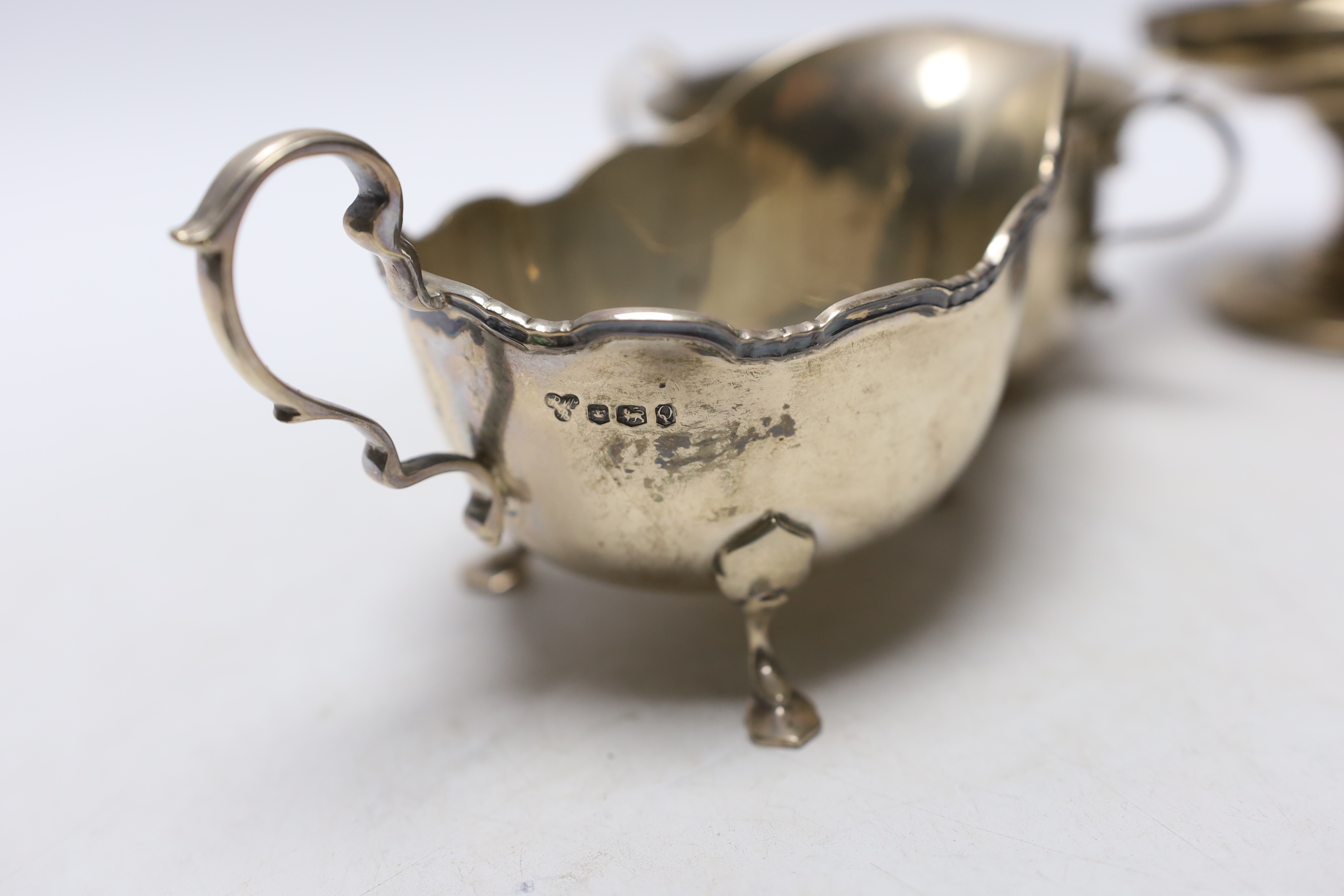 An Elizabeth II silver sauceboat, by Harrods Ltd, a silver two handled bowl and a pair of silver mounted pedestal bonbon dishes.